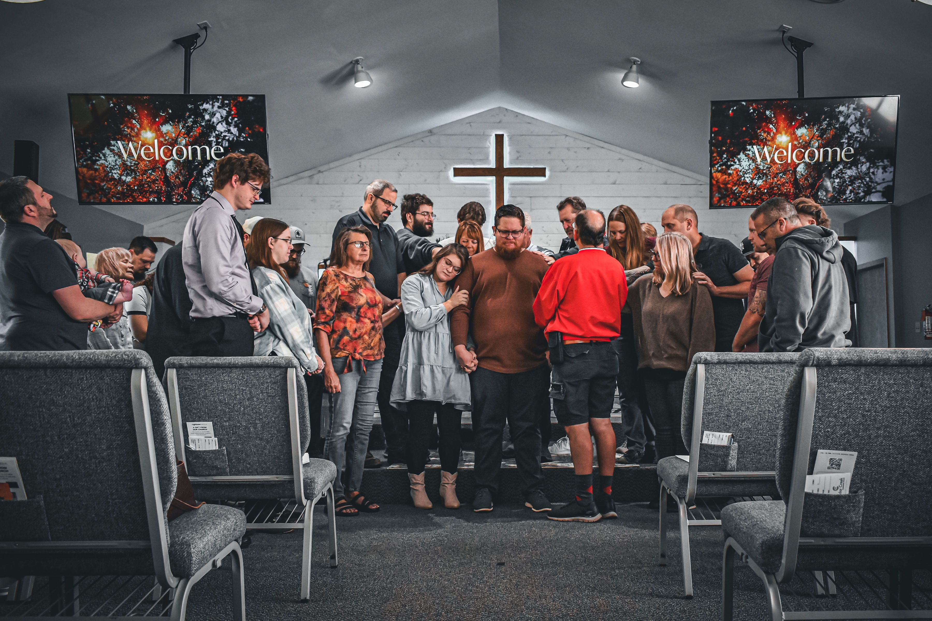 Cedar Creek’s church family gathering around one another in prayer